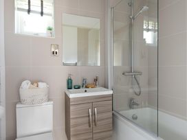 A bathroom with a sink and shower at Sennen 3 Spa Roof Terrace, Bude