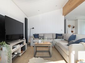 A living room with a sofa and coffee table at Sennen 3 Spa (Pet) Bude