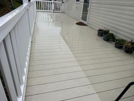 A deck area with plants and a door at Willerby Ellerrton (delyn) Prestatyn