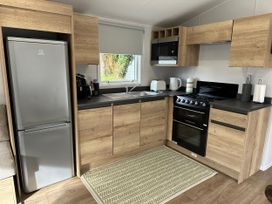 A kitchen with appliances and cabinetry at Willerby Ellerrton (delyn) Prestatyn