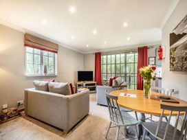 A living room with a sofa and dining area at Arran Lodge Spa Dailly