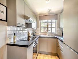 A kitchen with cabinets, stove, and sink at Arran Lodge Spa in Dailly