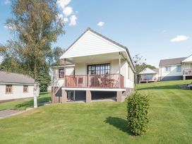 A house with a balcony in a garden at Turnberry in Dailly