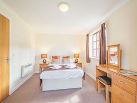 A bedroom with a bed and dressing table at Turnberry in Dailly