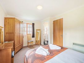 A bedroom with a bed and wardrobe at Turnberry in Dailly