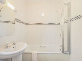 A bathroom with a sink, bathtub, and shower at Turnberry in Dailly