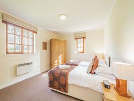 A bedroom with two beds and wooden wardrobe at Turnberry in Dailly