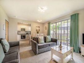 A living room with a sofa and dining area at Brunston in Dailly