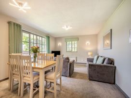 A living room with a dining table and sofa at Brunston in Dailly