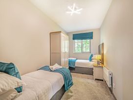 A bedroom with two beds and a wardrobe at Brunston in Dailly