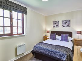 A bedroom with a double bed and window at Brunston (Pet) Dailly