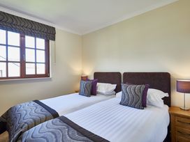 A bedroom with twin beds and a window at Brunston (Pet) Dailly