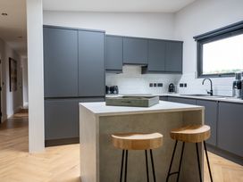 A kitchen with gray cabinets and a countertop at Cabin 2.0 in Dumfries