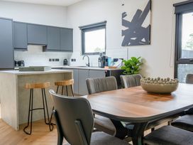 A kitchen with a dining area and appliances at Cabin 2.0 Luxe (Pet) in Dumfries