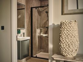 A bathroom with a shower and sink at Cabin 2.0 Deluxe in Dumfries