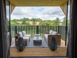 A balcony with seating and table at Orka 2.0 Kinder (Pet) Dumfries