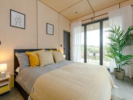 A bedroom with a bed and window at Orka Duo 2.0 (Pet) Dumfries