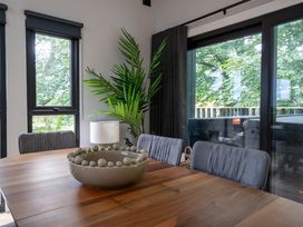 A dining room with a wooden table and chairs at Cabin 3.0 Deluxe in Dumfries