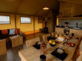 A dining area with a table and kitchen counter at Standard Safari Tent in Fair Oak