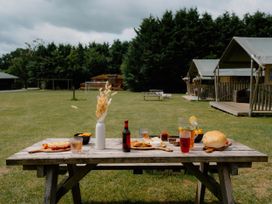 A table with food and drinks at Standard Safari Tent in Fair Oak