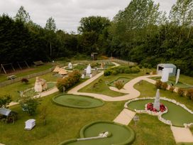 An outdoor minigolf course with pathways and landscaping at Standard Safari Tent in Fair Oak