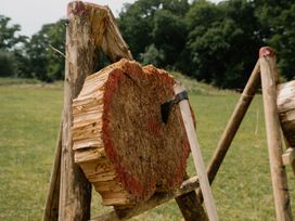 A cut tree trunk with an axe at a wood chopping area in Fair Oak