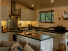 A kitchen with a sink and stove at Spitfire Lodge in Fair Oak