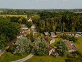An aerial view of buildings surrounded by trees and fields at Spitfire Lodge in Fair Oak