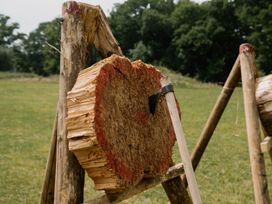 A wooden log with an axe in it at Spitfire Lodge Fair Oak