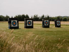 Archery targets arranged in a line in a field at Lancaster Lodge in Fair Oak