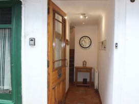 A hallway with a clock and a table at The Little Clock House in Dartmouth