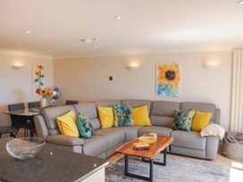 A living room with a sofa and coffee table at 8 Thurlestone Beach in Kingsbridge