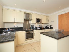 A kitchen with cabinets, appliances and a countertop at 8 Thurlestone Beach in Kingsbridge