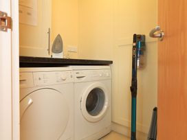 A laundry room with a washing machine and dryer at 8 Thurlestone Beach in Kingsbridge