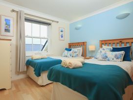 A bedroom with two beds and a chest of drawers at 8 Thurlestone Beach in Kingsbridge