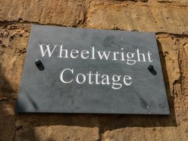A sign for Wheelwright Cottage in Moreton-In-Marsh