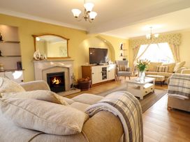 A living room with a fireplace and sofa at Llwyn Derw Talybont