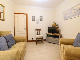 A living room with a television and seating at Llwyn Derw in Talybont