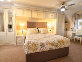 A bedroom with a bed and wardrobe at Llwyn Derw in Talybont