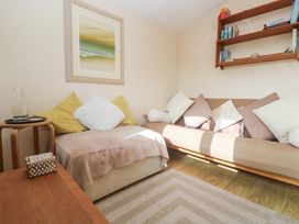 A snug with a sofa and wall art at Chalet 225 in Tregolds near St Merryn