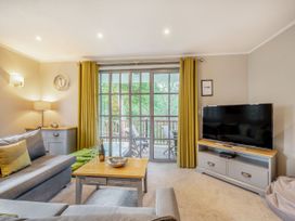 A living room with a sofa and TV at Ailsa Craig Spa in Dailly