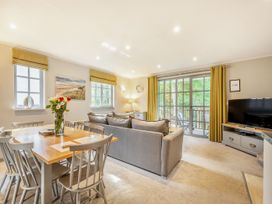 A living room with a dining table and a sofa at Ailsa Craig Spa in Dailly