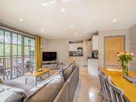 A living room with a sofa and dining table at Ailsa Craig Spa Dailly