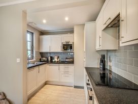 A kitchen with modern cabinets and appliances at Ailsa Craig Spa Dailly