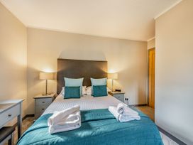 A bedroom with a bed and lamps at Ailsa Craig Spa Dailly