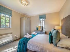 A bedroom with a bed and wardrobe at Ailsa Craig Spa Dailly