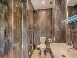 A bathroom with shower, toilet, and sink at Ailsa Craig Spa Dailly