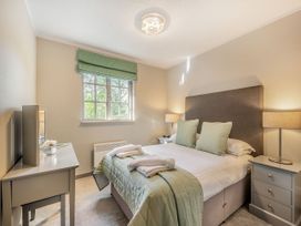 A bedroom with a bed and nightstand at Ailsa Craig Spa in Dailly