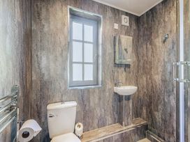 A bathroom with a toilet and sink at Ailsa Craig Spa in Dailly