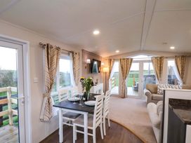 A dining area with a table and chairs at Rosefinch Cabin in Scarborough